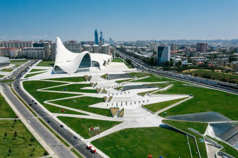 Stunning aerial shot of the Heydar Aliyev Center and urban landscape in Baku, Azerbaijan.