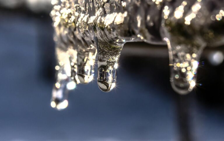 Macro shot of icicles glistening in the sunlight, capturing the essence of winter.
