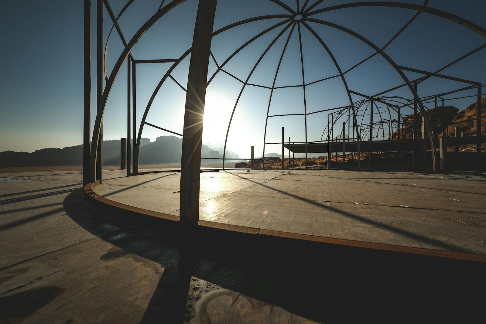 Sunlit silhouette of a dome structure in the Wadi Rum desert, Jordan. Perfect for themes of construction, adventure.